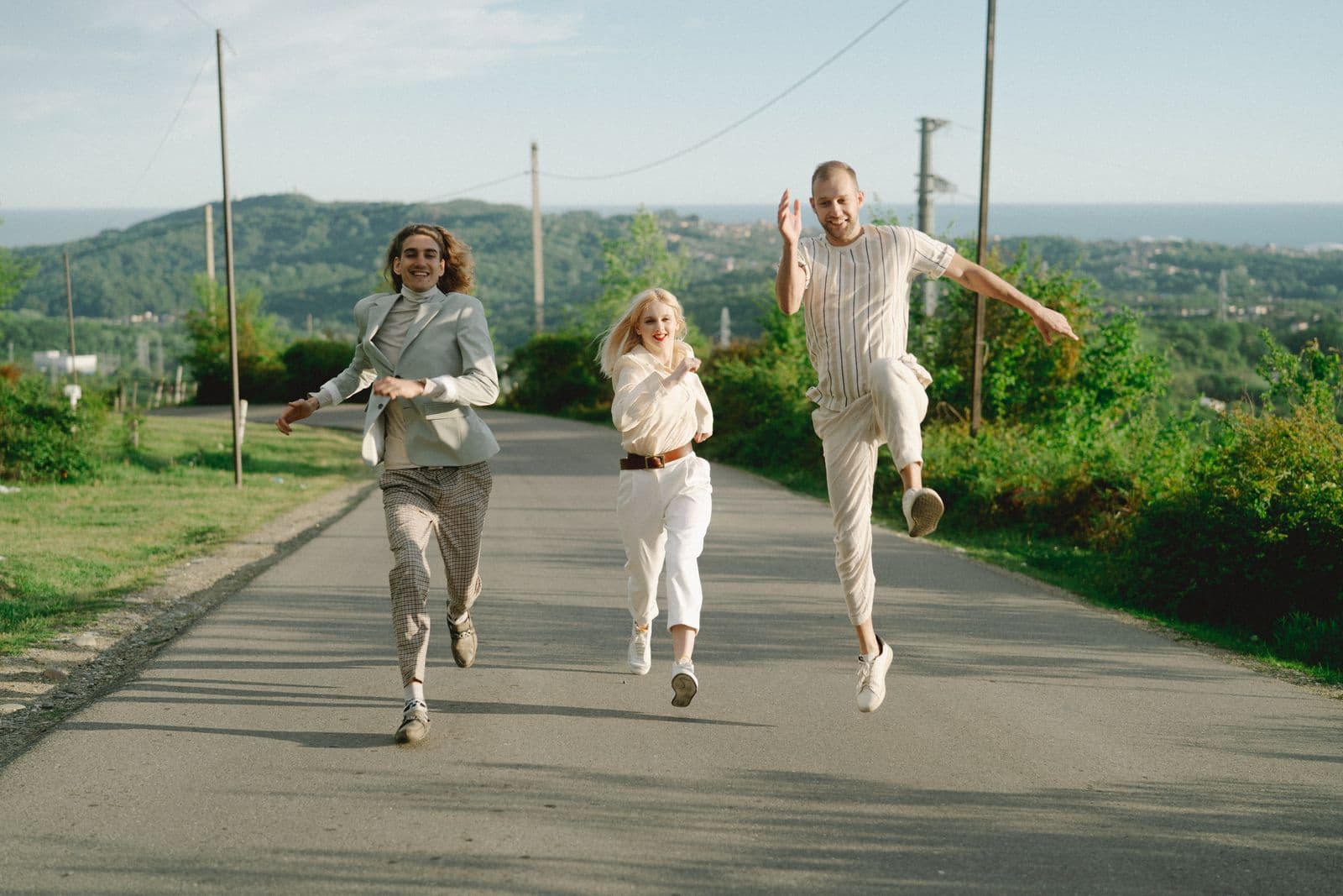 University-age friends moving forward together on a summer road